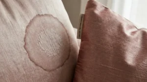 Close up of water stain damage on a silk blend sofa fabric from incorrect cleaning