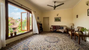 Freshly cleaned carpet drying with fan and open window in Lahore